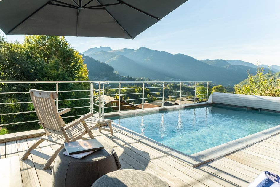 External of Alpine Retreat, a summer chalet in Morzine with a pool, along with stunning mountain views.