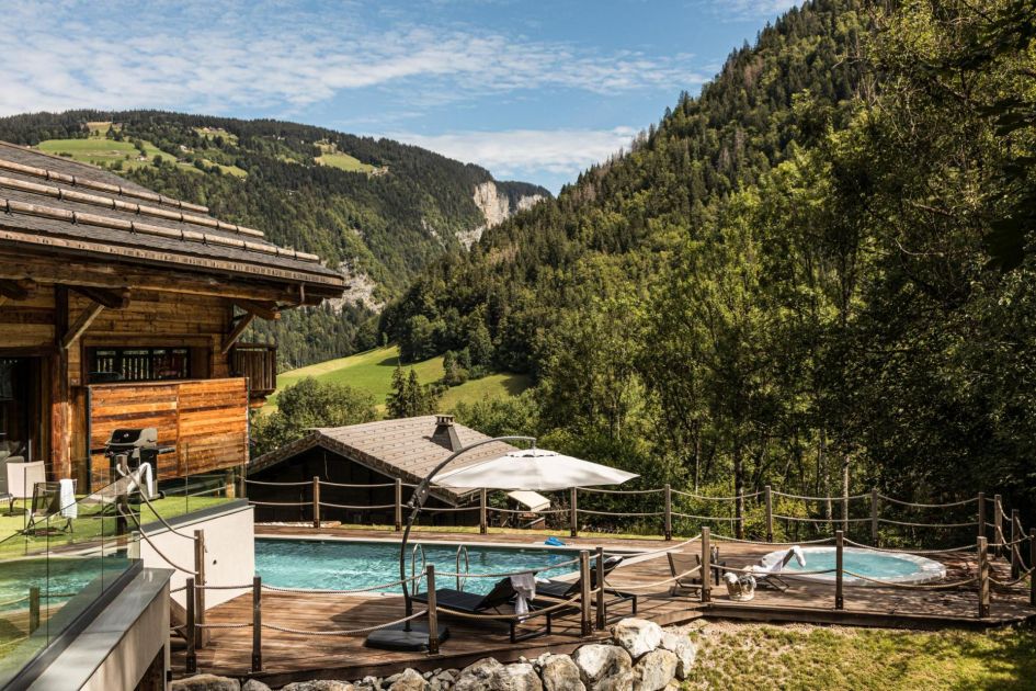 Chalet Joux Plane's outdoor space features views across the valley, as well as a swimming pool and hot tub - perfect for relaxing on those luxury mountain biking holidays in Morzine!