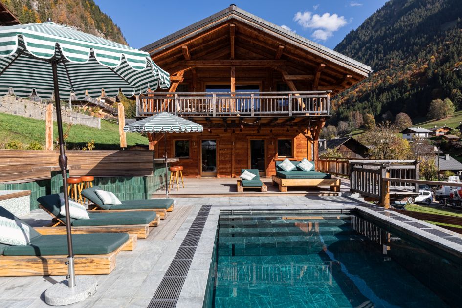 External of Chalet Doyen, showing outdoor terrace area and swimming pool in Morzine.