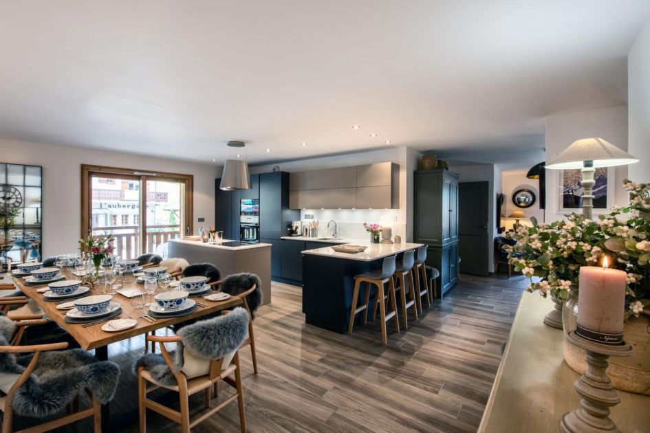 Interiors of Les Abeilles, featuring an open-plan design housing a number of modern furnishings in this kitchen-dining space, all found within a great location to fully make the most of luxury mountain biking holidays in Morzine!