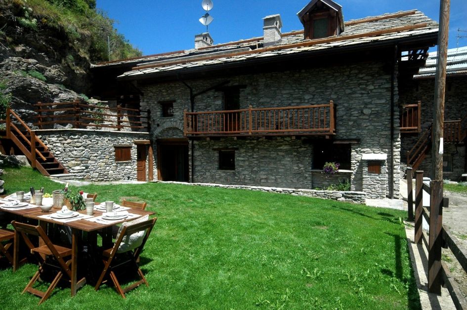 An exterior shot and the garden of Baita 1697 in summer, a Sestriere chalet found just down the valley in Pragelato.