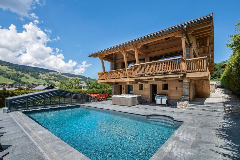 The outside patio with swimming pool and BBQ. One of the best self catered mountain chalets France. 