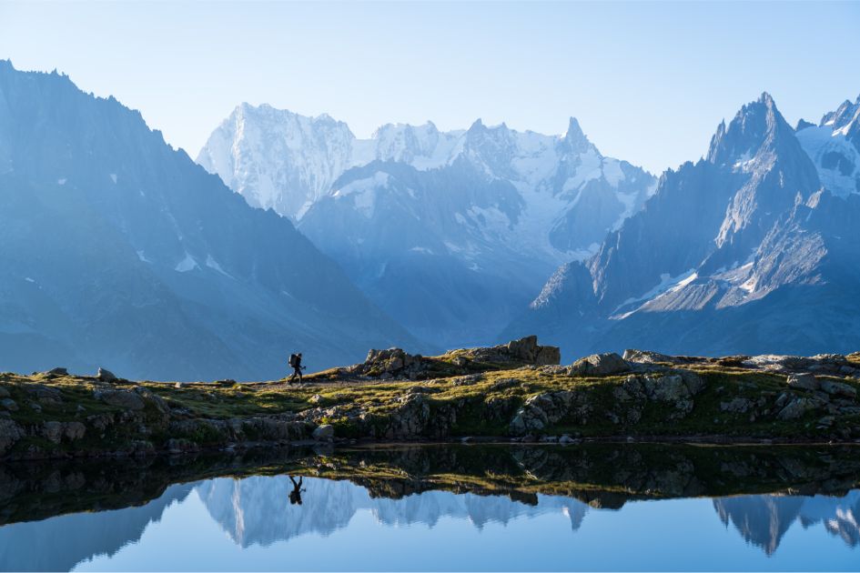 The Tour du Mont Blanc is one of the best hikes in the Alps. Perfect for luxury walking holidays in Europe, the route encompasses views of the majestic Mont Blanc region and lakes in the Alps as seen in this photo!