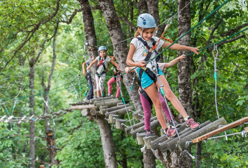 Children walking along a rope bridge in the Forest of Adventurers, a great family activity on a summer holiday in St Martin de Belleville