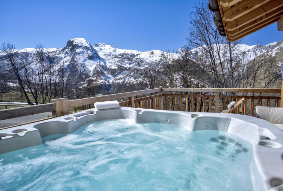 Hot tub with mountain views at Chalet Aralia, one of the best luxury summer chalets in St Martin de Belleville.