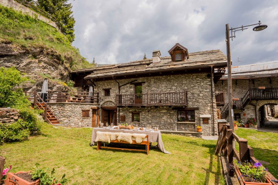 An exterior shot and the garden of Baita 1697 in summer, a Sestriere chalet found just down the valley in Pragelato.